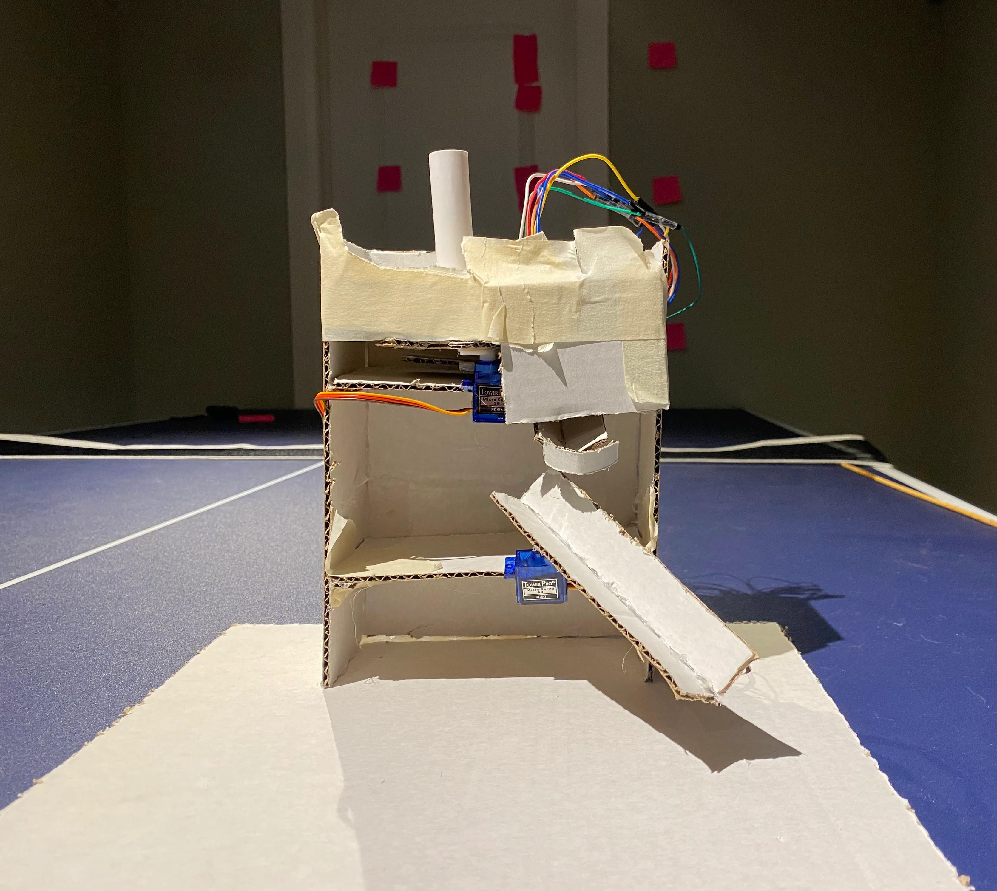 Skittle sorter. Skittles are loaded from the tube on top and get sent down the sled at different angles depending on color. Skittle color containers not shown, see video for details. 